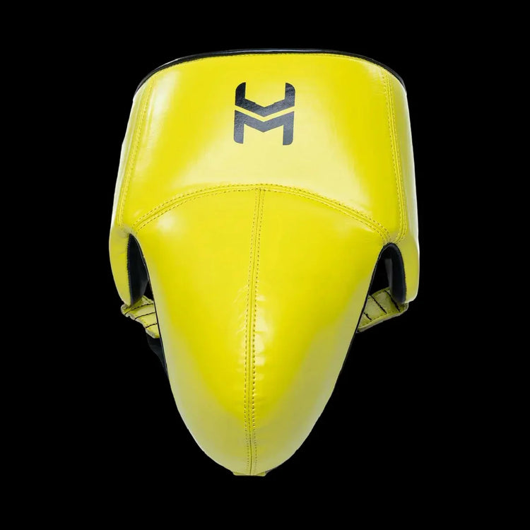 Yellow boxing groin protector with black logo, pro-grade protective gear on black background