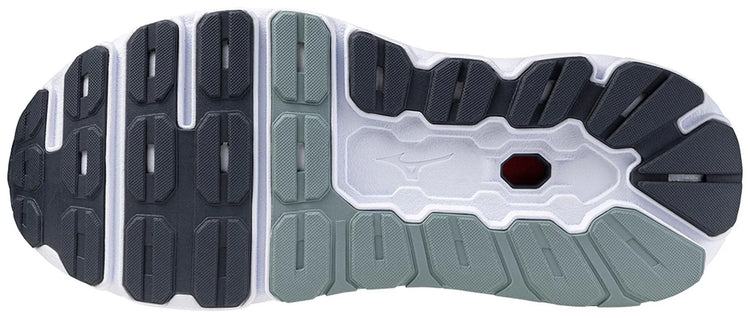 Close-up of a sports shoe outsole with textured grip and multi-tone rubber tread design