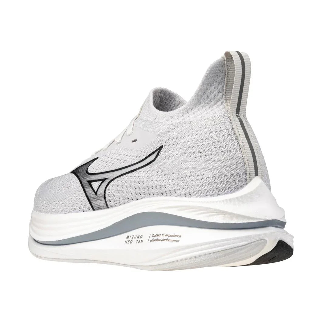 White athletic sneaker with black logo, mesh upper, and thick cushioned sole, side view