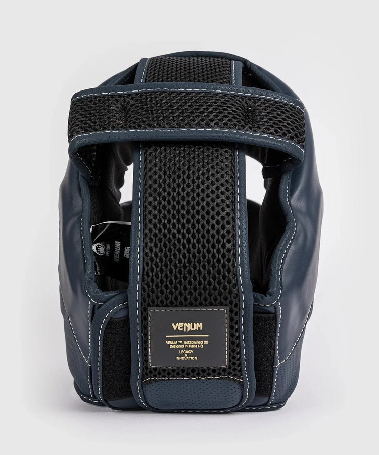 Black leather boxing headgear with mesh padding and Venum brand label, rear view