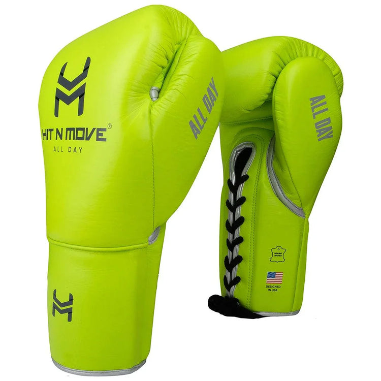 Neon green lace-up boxing gloves with black laces and 'ALL DAY' text on each glove.