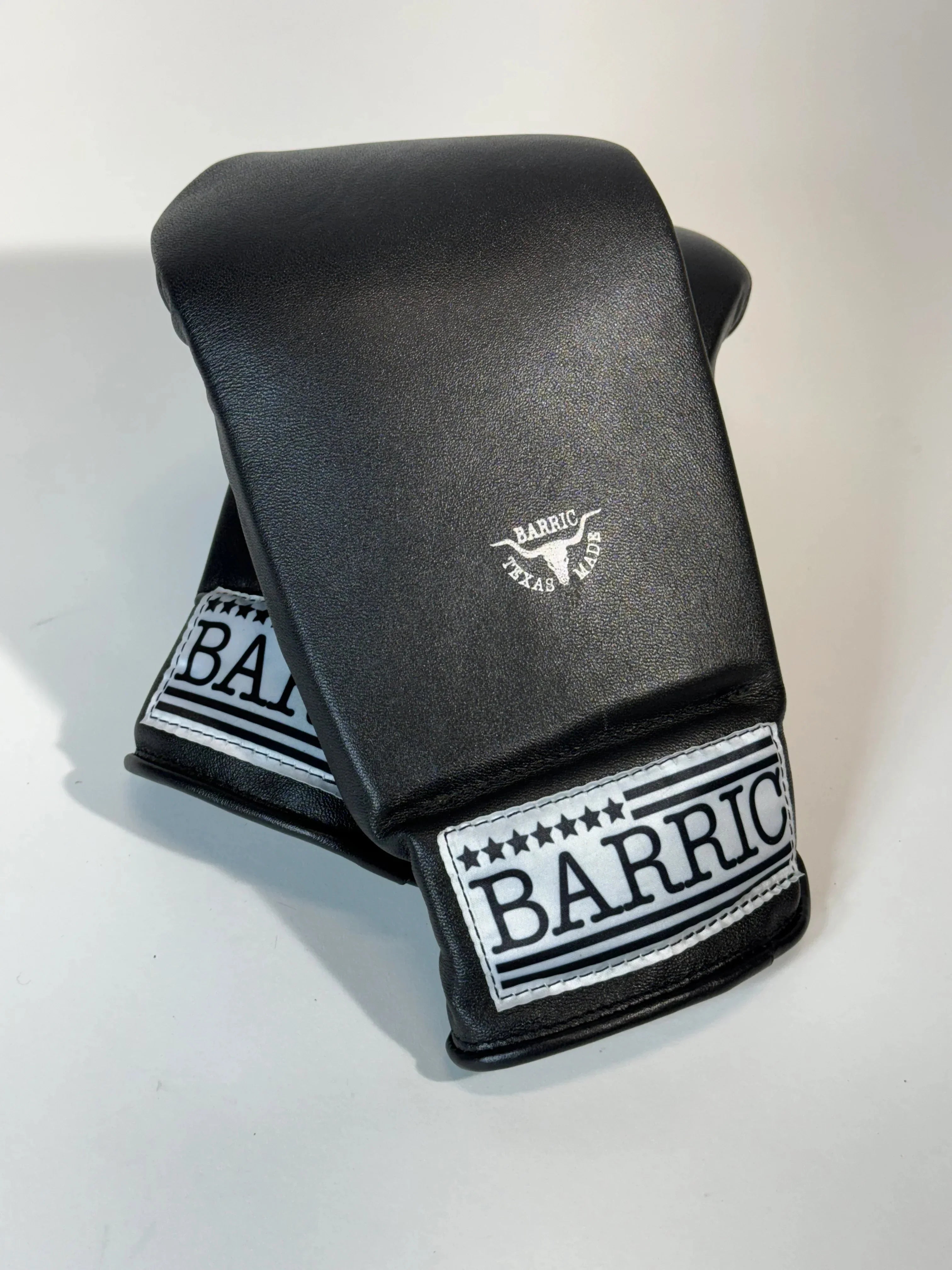 Black leather boxing mitts with BARRIC logo and Texas Made label on white background