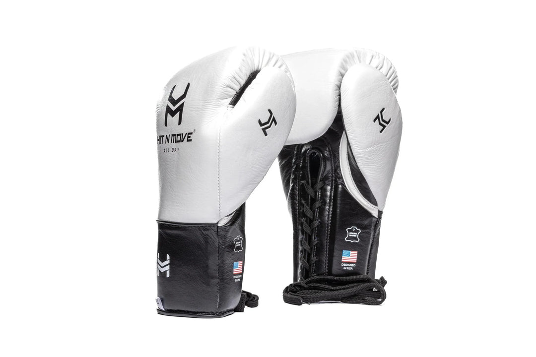 Black and white lace-up boxing gloves with Hit N Move logo on white background.