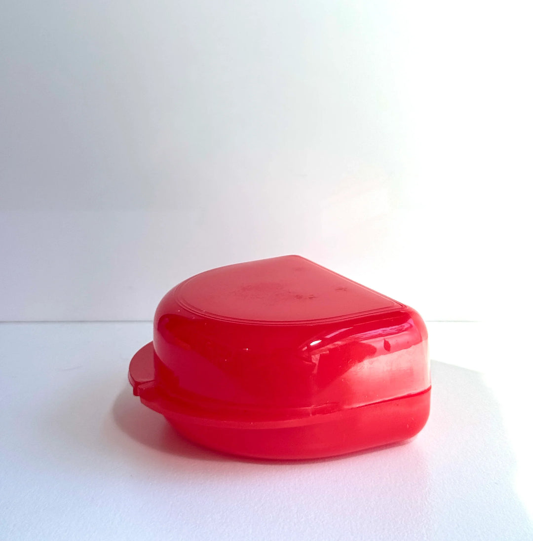 Red boxing mouthguard case on a white background