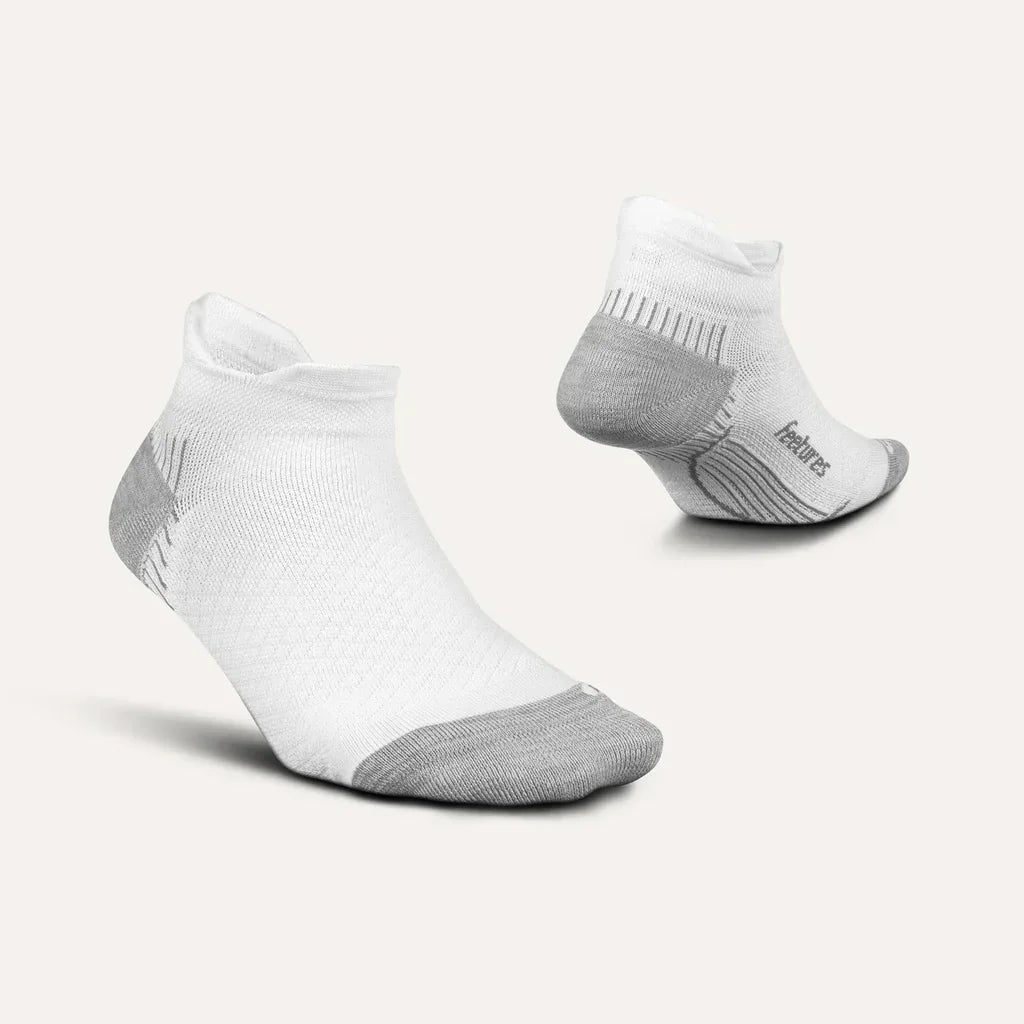 White and gray low-cut athletic socks with cushioned sole on neutral background