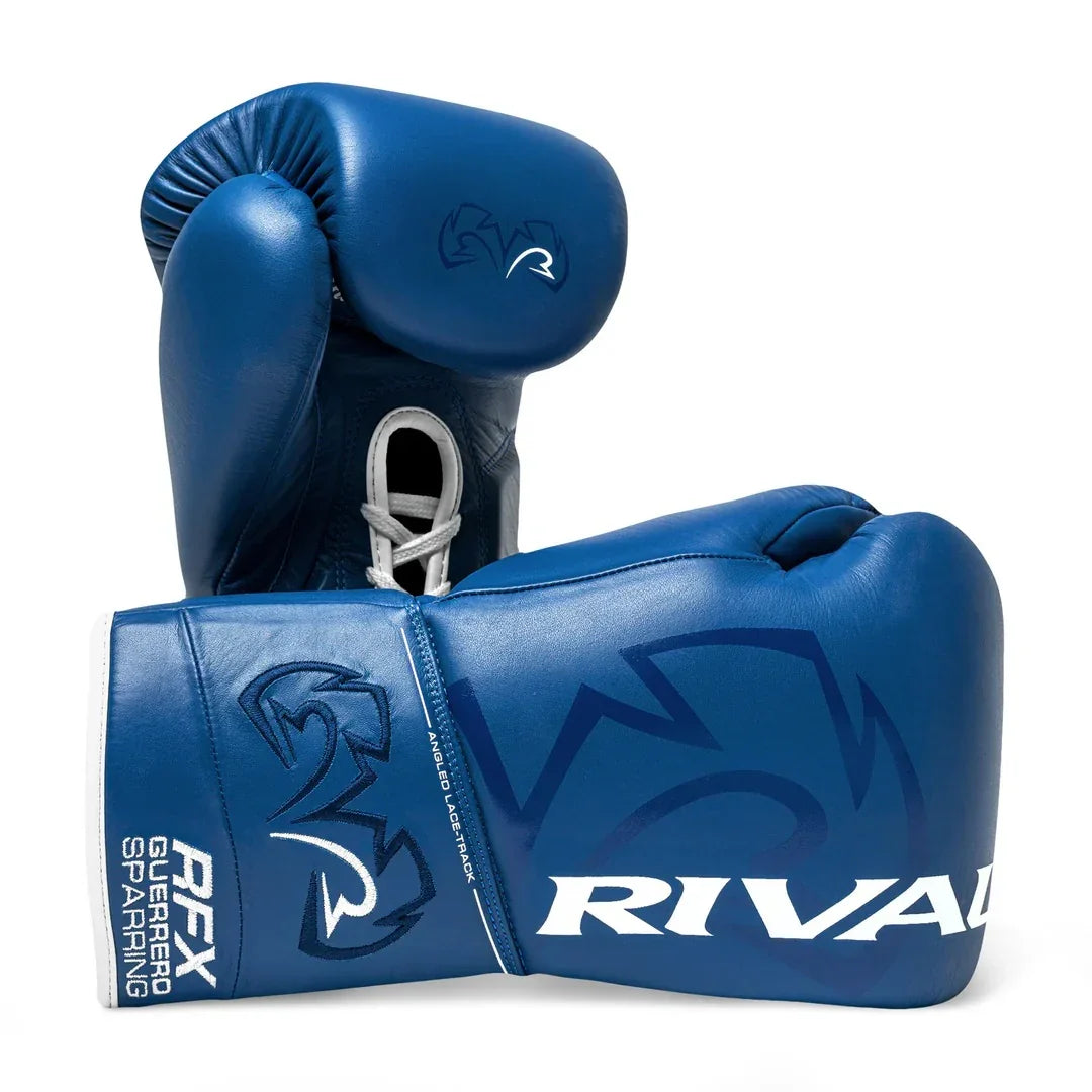 Blue lace-up sparring boxing gloves with Rival logo and embossed graphics, isolated on white background