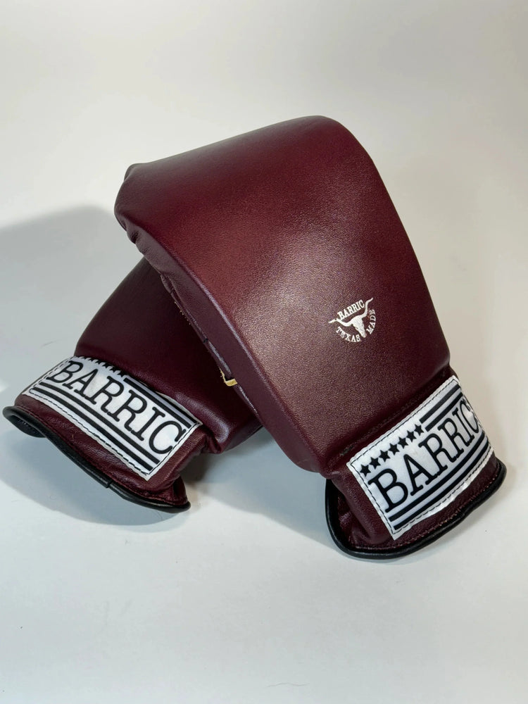 Pair of maroon leather boxing mitts with Barric logo, pro training gear on white background