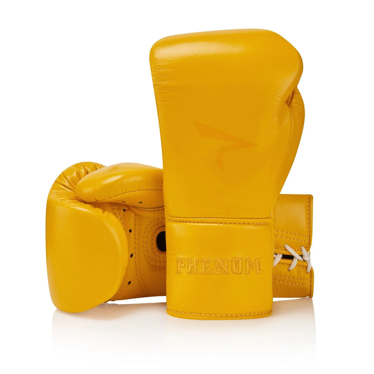 Pair of yellow lace-up leather sparring boxing gloves with PHENOM logo on wrist