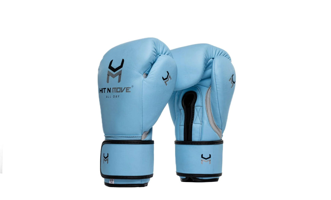 Sky blue boxing gloves with black and silver accents, pro-grade leather equipment on white background