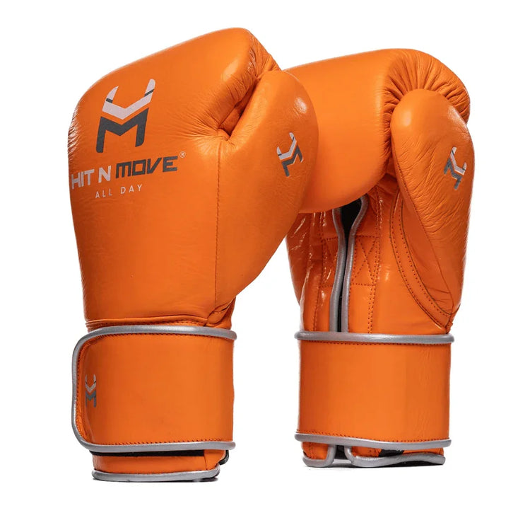 Orange leather boxing gloves with silver trim, 'HIT N MOVE' logo, front and back view
