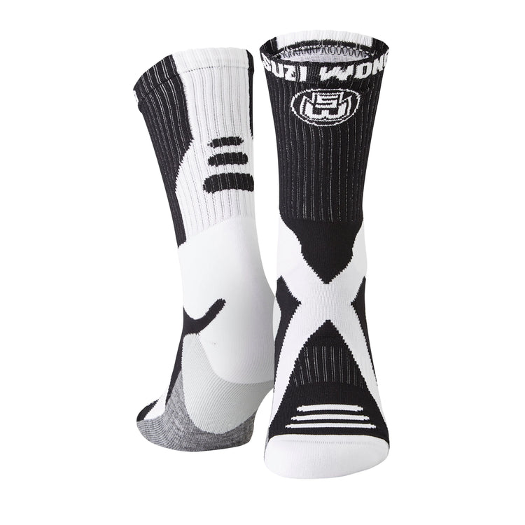 White, black, and grey athletic socks with bold patterns and cushioned soles, standing upright.