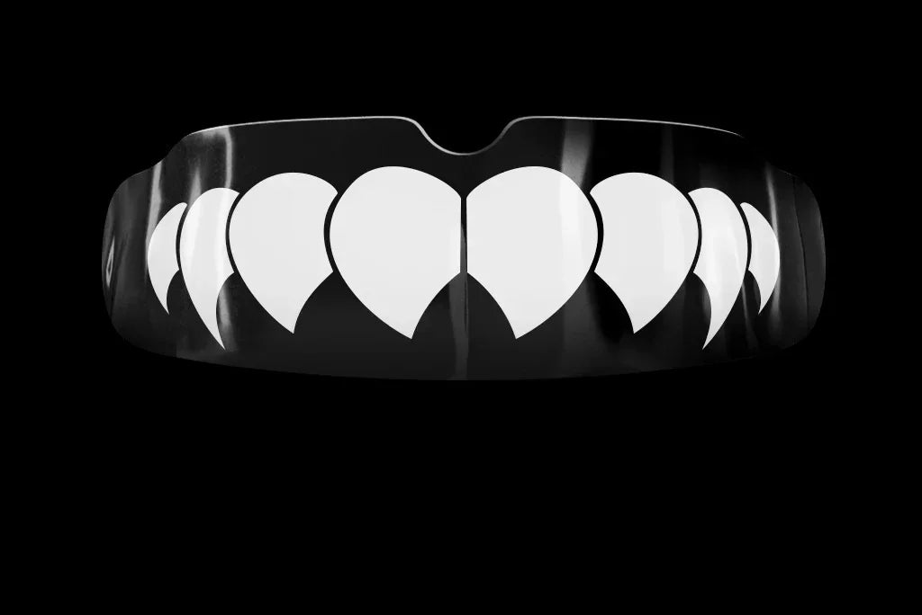 Black boxing mouthguard with white fang design on black background