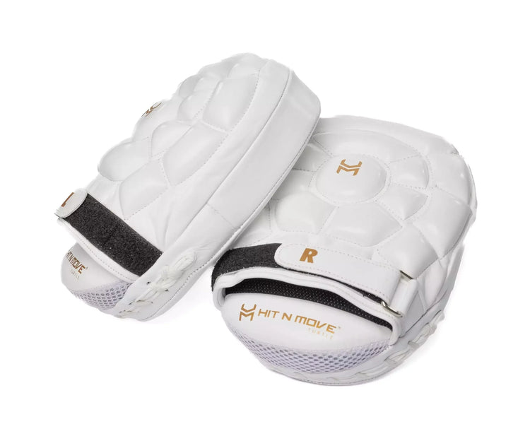 White boxing focus mitts with quilted padding and 'Hit N Move' logo on white background