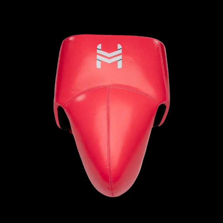 Red boxing groin protector with white chevron logo on black background