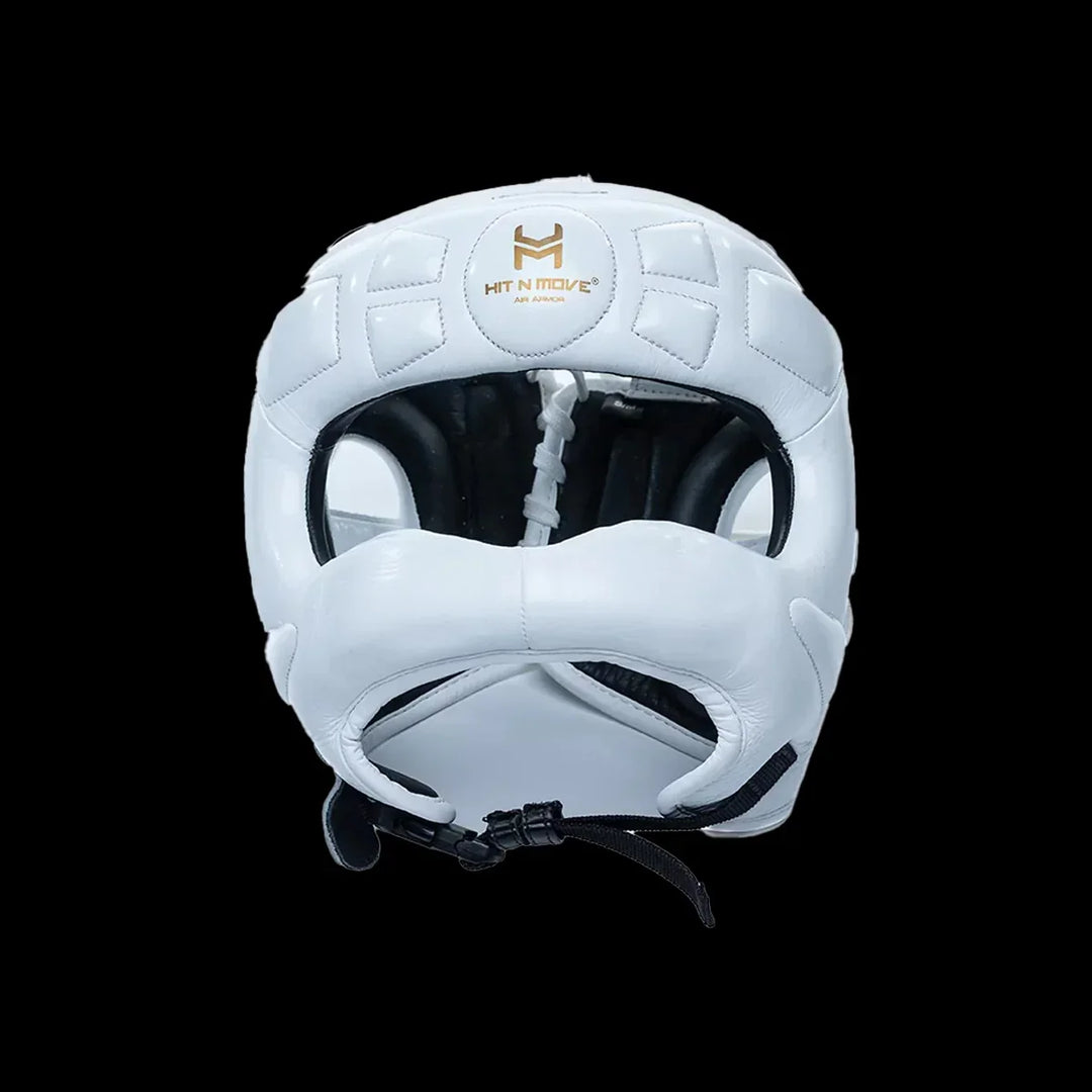 White boxing headgear with face protection and HIT N MOVE logo on front, black background