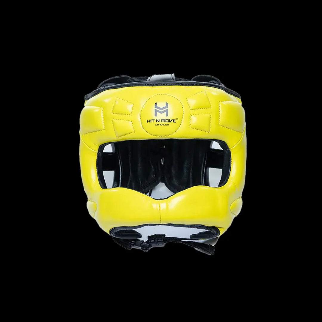 Yellow boxing headgear with face protection and black inner padding on black background