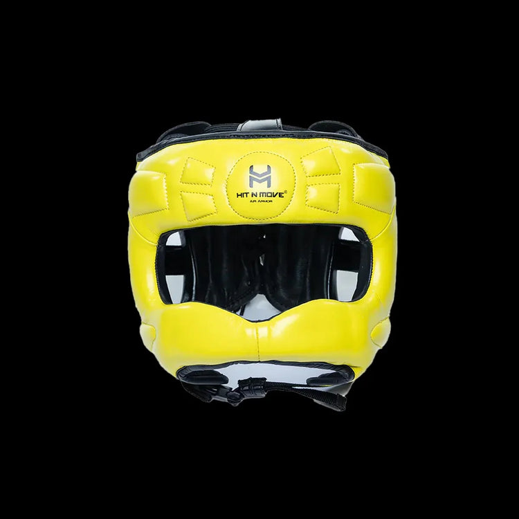 Yellow boxing headgear with face protection and black inner padding on black background